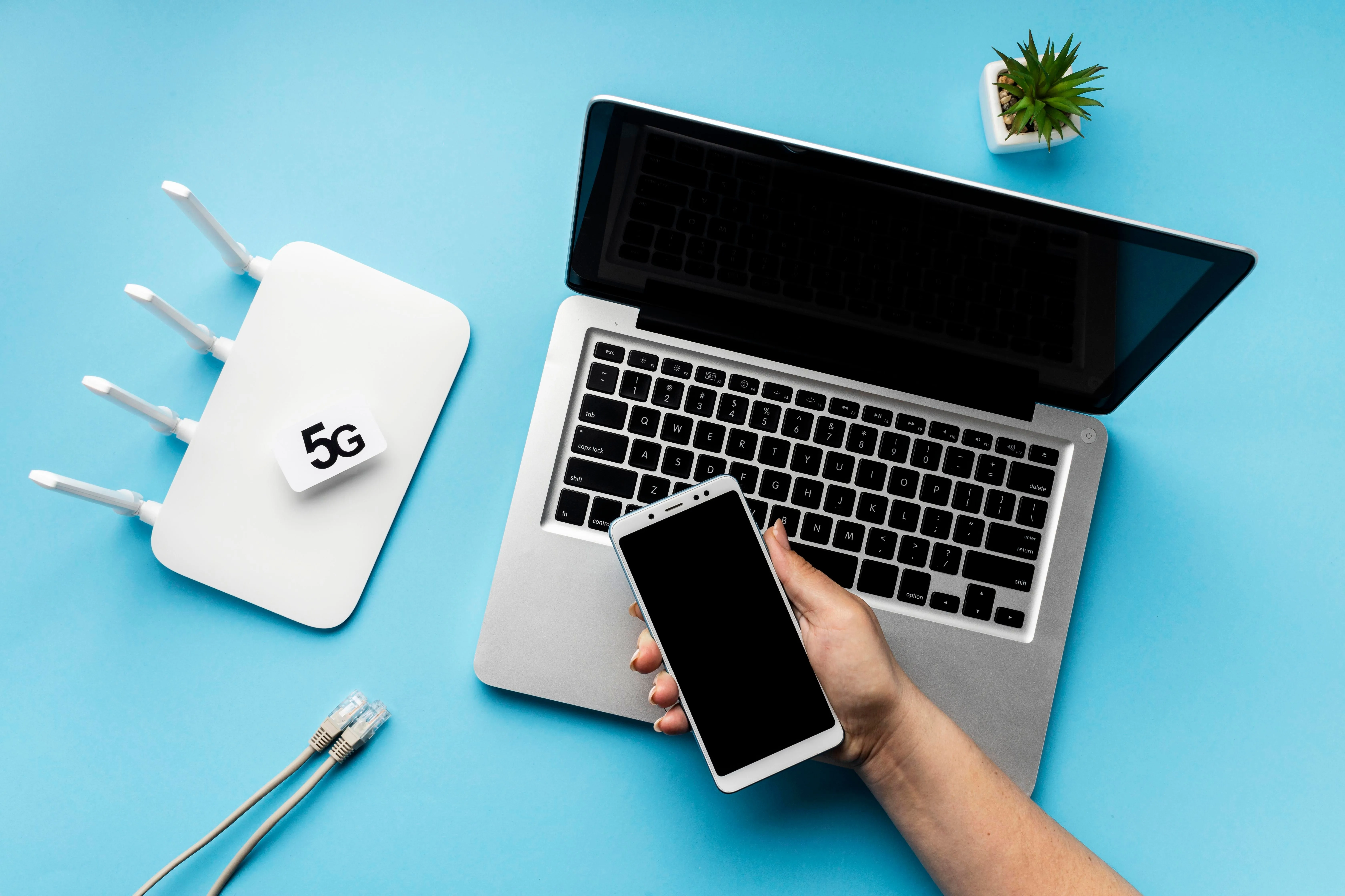 top-view-wi-fi-router-with-laptop-hand-holding-smartphone.jpg